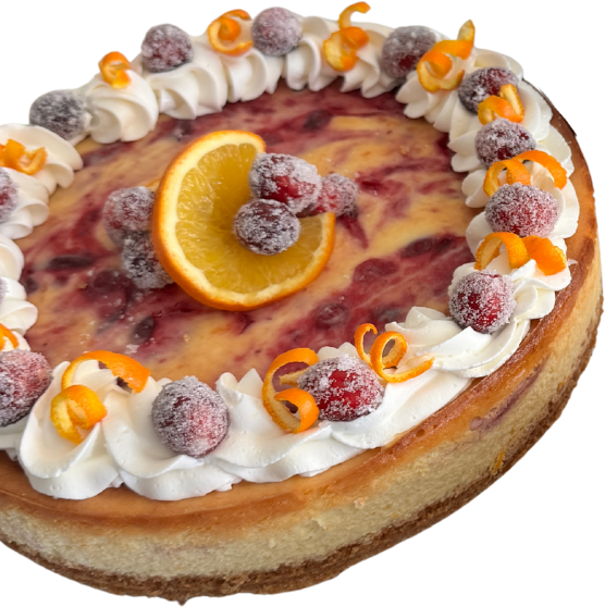 A cranberry and orange swirl cheesecake, ringed with piped cream, sugared cranberries and curls of orange peel