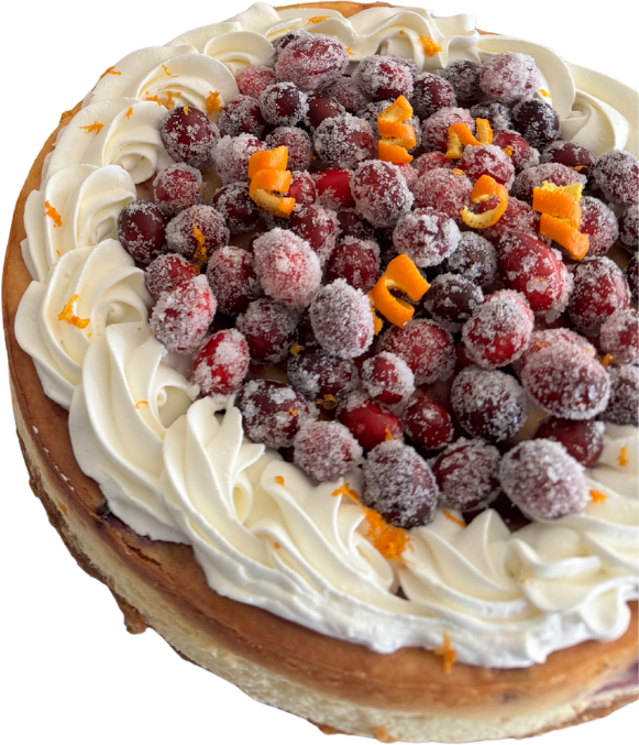 A cheesecake piled with sugared cranberries and orange zest inside a border of piped cream